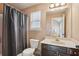Bathroom featuring vanity, framed mirror, shower with curtain, and toilet at 4316 Constellation Blvd, Snellville, GA 30039