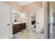Spacious bathroom with dual sinks, dark wood cabinets, and a view into the bedroom at 4316 Constellation Blvd, Snellville, GA 30039