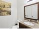 Powder room featuring granite countertop, framed mirror, and neutral color palette at 4316 Constellation Blvd, Snellville, GA 30039