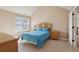 Bedroom with blue bedding, natural wood furniture, large window, and doorway at 4316 Constellation Blvd, Snellville, GA 30039