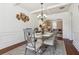 Elegant dining room featuring a modern chandelier, stylish metal wall decor, and seating for six at 4316 Constellation Blvd, Snellville, GA 30039