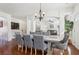 Bright dining room with wood floors, grey upholstered chairs, and chandelier lighting for a warm and inviting atmosphere at 4316 Constellation Blvd, Snellville, GA 30039