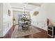 Refined dining room showcasing paneled walls, a modern chandelier, and an elegant glass-top table for formal meals at 4316 Constellation Blvd, Snellville, GA 30039
