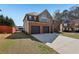 Charming brick front exterior with a two-car garage and a lush green lawn, creating a welcoming curb appeal at 4316 Constellation Blvd, Snellville, GA 30039