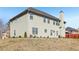Two-story home with beige siding, a chimney, and sliding glass door to backyard at 4316 Constellation Blvd, Snellville, GA 30039
