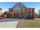 Inviting two-story brick home featuring a two-car garage and well-maintained lawn on a sunny day at 4316 Constellation Blvd, Snellville, GA 30039
