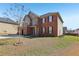Brick home featuring a two-car garage, complemented by a well-manicured lawn and tasteful landscaping at 4316 Constellation Blvd, Snellville, GA 30039
