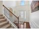 Bright foyer featuring hardwood floors, staircase with decorative iron railing and plenty of natural light at 4316 Constellation Blvd, Snellville, GA 30039