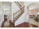 Elegant foyer featuring hardwood floors, a staircase with wrought iron spindles, and views of the living spaces at 4316 Constellation Blvd, Snellville, GA 30039