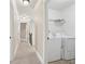 Upstairs hallway featuring access to laundry room with washer and dryer at 4316 Constellation Blvd, Snellville, GA 30039