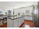 Kitchen with an island, granite counters, and stainless steel appliances, seamlessly connecting living spaces at 4316 Constellation Blvd, Snellville, GA 30039