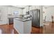Open kitchen with stainless steel appliances, granite countertops, white cabinetry, and an island at 4316 Constellation Blvd, Snellville, GA 30039