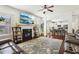 Open-concept living room with fireplace, TV, modern furniture, and hardwood floors at 4316 Constellation Blvd, Snellville, GA 30039
