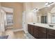 Bathroom featuring dual sinks with a dark wood vanity and a walk-in shower at 4316 Constellation Blvd, Snellville, GA 30039