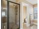 Updated shower with a tiled surround, glass door, and neutral color palette at 4316 Constellation Blvd, Snellville, GA 30039