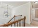 Staircase landing featuring chandelier, wrought iron railing, and natural light at 4316 Constellation Blvd, Snellville, GA 30039