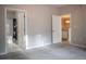 Bedroom with grey carpet flooring, and two entrances to the bathroom and kitchen at 101 Spring Heights Se Ln # 1, Smyrna, GA 30080