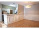 Dining area featuring decorative wall trim, modern chandelier, and a partial view of the kitchen at 101 Spring Heights Se Ln # 1, Smyrna, GA 30080