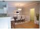 Dining room with modern light fixture, table, and chairs next to the kitchen at 101 Spring Heights Se Ln # 1, Smyrna, GA 30080