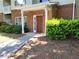 Brick building entrance with a red door, surrounded by green shrubs and a concrete walkway at 101 Spring Heights Se Ln # 1, Smyrna, GA 30080
