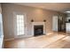 Bright living room with a fireplace, wood floors, and a door leading to the outside at 101 Spring Heights Se Ln # 1, Smyrna, GA 30080