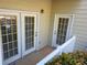 Covered patio area featuring three access doors and a white railing at 101 Spring Heights Se Ln # 1, Smyrna, GA 30080