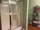 Clean bathroom showcasing a glass-enclosed shower with built-in seating and metal shelving at 119 Holiday Rd # 704, Buford, GA 30518