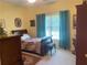 Bright bedroom featuring patterned bedding, carpet flooring, and a sunny window at 119 Holiday Rd # 704, Buford, GA 30518