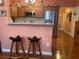 Kitchen view highlighting barstool seating, stainless steel appliances, and wooden cabinetry at 119 Holiday Rd # 704, Buford, GA 30518