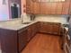 Kitchen with stainless steel appliances, granite countertops, wooden cabinetry, and access to barstool seating at 119 Holiday Rd # 704, Buford, GA 30518