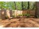 Private backyard with stone benches and a lush border of verdant foliage and a wooden fence at 129 Ridgetree Ln, Marietta, GA 30068