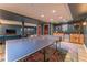 Finished basement with a ping pong table, wet bar with light colored wood cabinets, and colorful accent rug at 129 Ridgetree Ln, Marietta, GA 30068