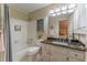 Bathroom with a combination shower/tub with gray curtain and vanity with a black counter top at 129 Ridgetree Ln, Marietta, GA 30068