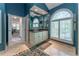 Elegant bathroom with a white vanity, travertine flooring, a large window with shutters, and access to the main bedroom at 129 Ridgetree Ln, Marietta, GA 30068