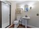 Bathroom featuring white pedestal sink, toilet and a glass enclosed shower at 129 Ridgetree Ln, Marietta, GA 30068