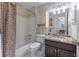 Full bathroom with shower-tub combination, stylish vanity, tiled walls, and a toilet with a white seat at 129 Ridgetree Ln, Marietta, GA 30068