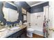 Charming bathroom featuring a granite countertop, decorative mirror and stylish shower curtain at 129 Ridgetree Ln, Marietta, GA 30068