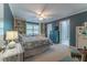 Comfortable bedroom with a ceiling fan, built-in shelving, window, and access to an ensuite bathroom at 129 Ridgetree Ln, Marietta, GA 30068