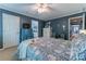 A cozy bedroom with stylish blue walls, a patterned bedspread, and a glimpse into the en suite bathroom at 129 Ridgetree Ln, Marietta, GA 30068
