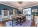 Beautiful dining room with a chandelier, hardwood floors, and adjacent living area at 129 Ridgetree Ln, Marietta, GA 30068