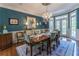 Elegant dining room with wainscoting, a chandelier, and ample natural light at 129 Ridgetree Ln, Marietta, GA 30068