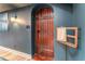 Arched door with a dark wood finish and metal accents against blue walls with wood floors at 129 Ridgetree Ln, Marietta, GA 30068