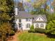 Charming two-story white home with manicured lawn and mature trees in a desirable neighborhood at 129 Ridgetree Ln, Marietta, GA 30068
