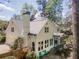 Stunning home exterior with a chimney, screened-in porch, pristine landscaping, and a backyard patio at 129 Ridgetree Ln, Marietta, GA 30068