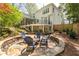 Multi-level backyard with stone patio, dining area, and lush landscaping offers an ideal outdoor retreat at 129 Ridgetree Ln, Marietta, GA 30068