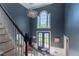Bright foyer with a colorful chandelier, arched window, and staircase at 129 Ridgetree Ln, Marietta, GA 30068