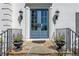 Elegant front door with sidelights, decorative lanterns, and stone steps, creating a welcoming entrance at 129 Ridgetree Ln, Marietta, GA 30068
