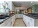 Open concept kitchen with granite countertops, light cabinets, and modern flooring at 129 Ridgetree Ln, Marietta, GA 30068