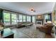 Sunlit living room with hardwood floors, fireplace, and large windows showcasing backyard at 129 Ridgetree Ln, Marietta, GA 30068