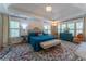 Bright bedroom with a tray ceiling, an ornate rug, and lots of windows with plantation shutters at 129 Ridgetree Ln, Marietta, GA 30068